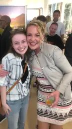 Katherine Heigl poses for a photograph with a fan at her 