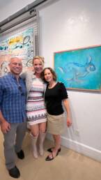 Katherine Heigl's and attendees pose with her mixed media work Winter Rabbit at her 